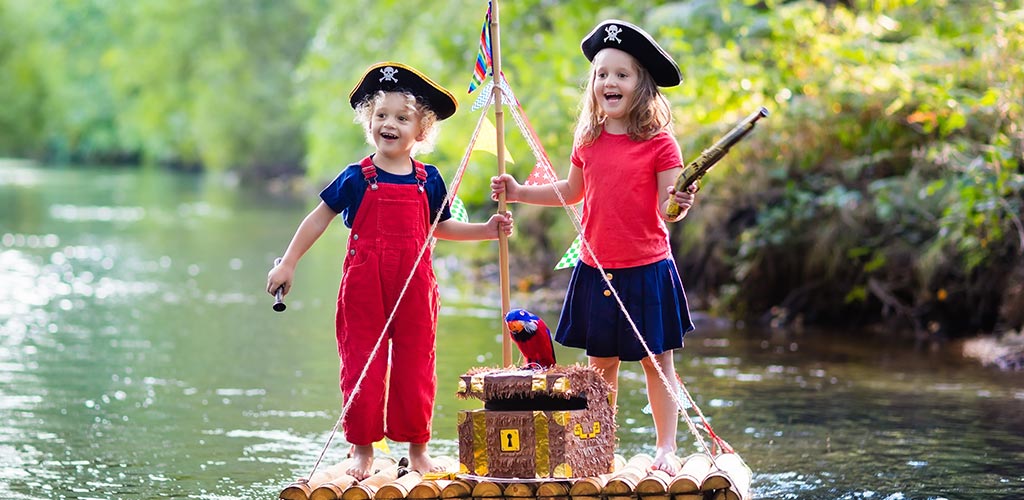 The Bats. Two young kids navigating a river on a raft Bats are experts in developing shared visioning programmes